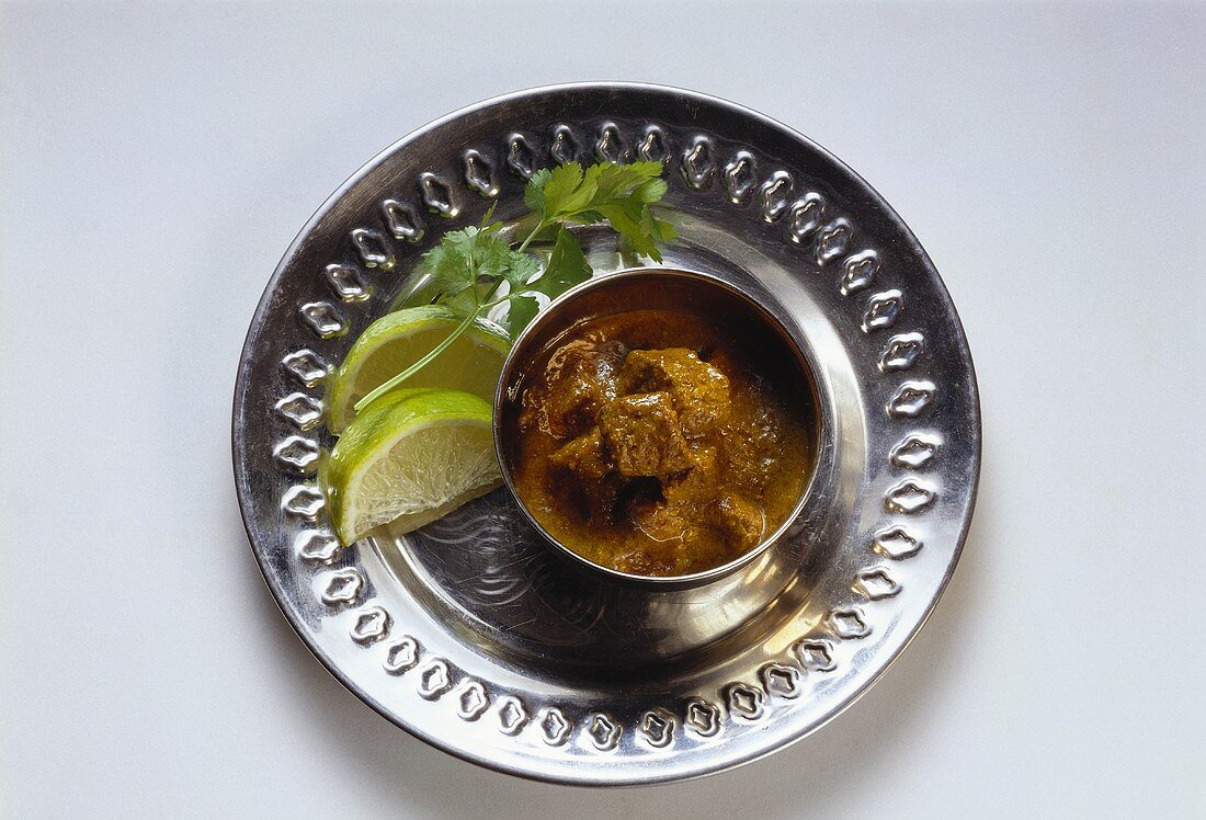 A bowl of hot and spicy lamb (Vindaloo) on tray