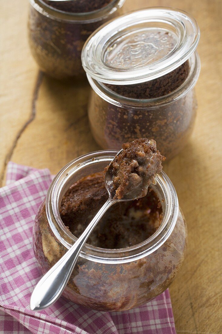 Three chocolate puddings baked in jars
