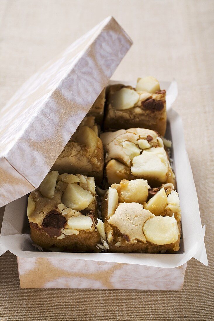 Small pieces of chocolate cake with macadamia nuts in box