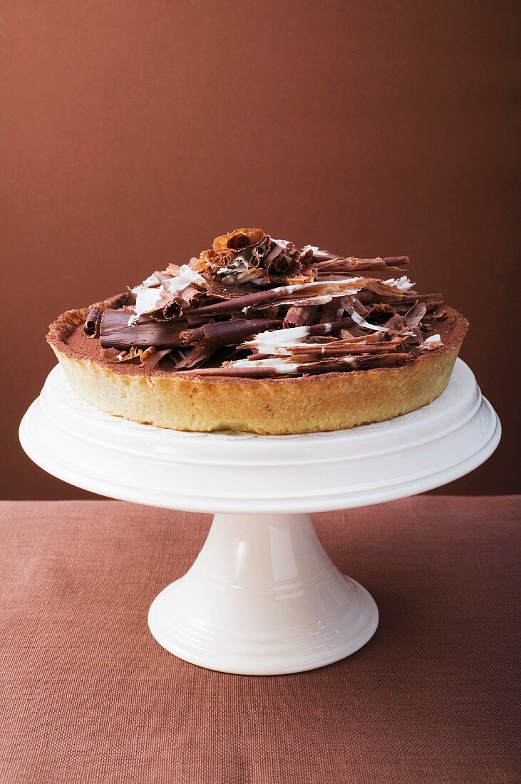 Whole chocolate tart on cake stand