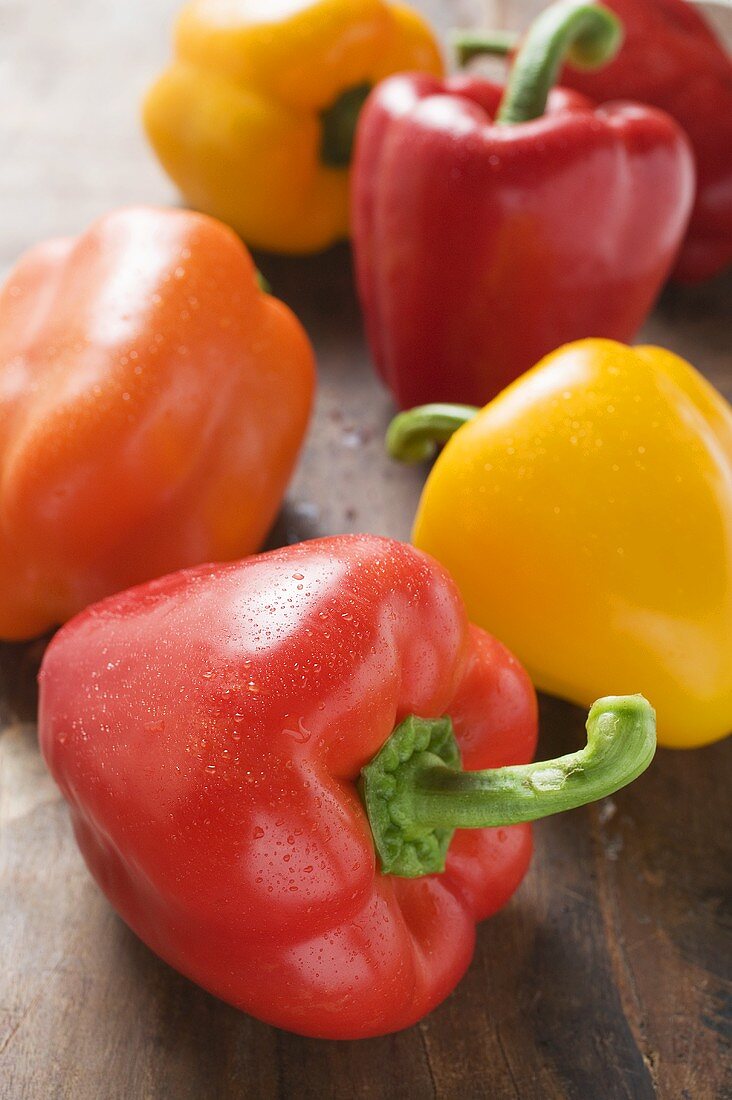 Yellow, orange and red peppers with drops of water