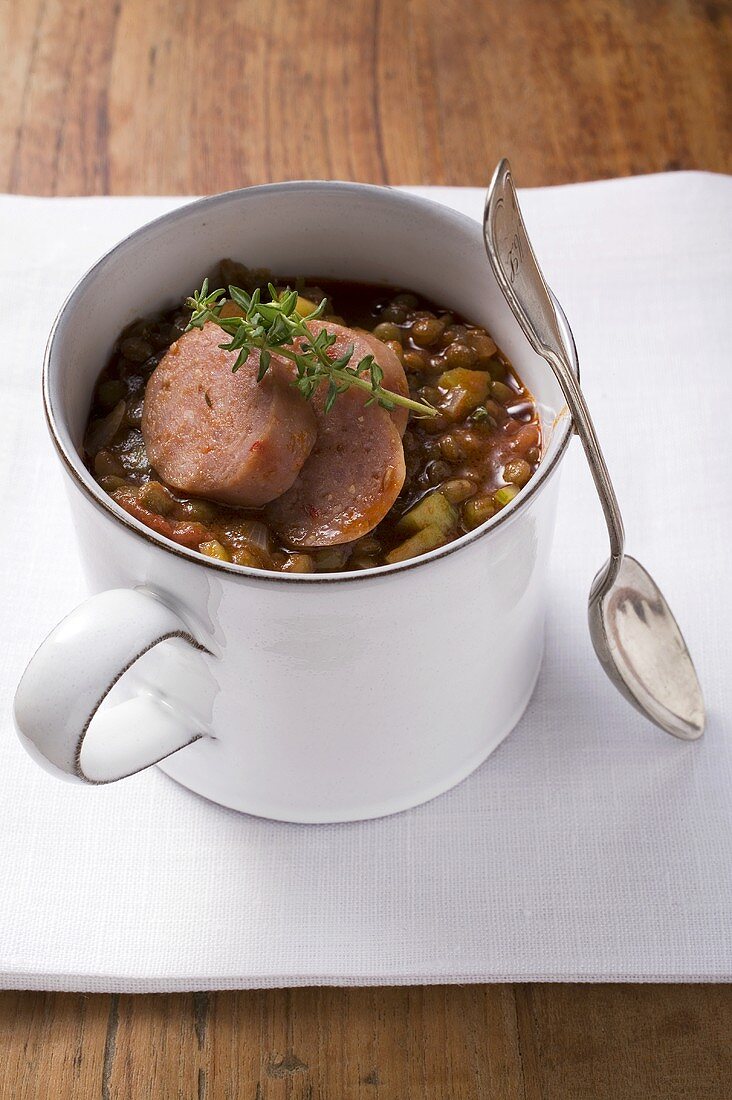 Lentil stew with sausage and thyme in mug