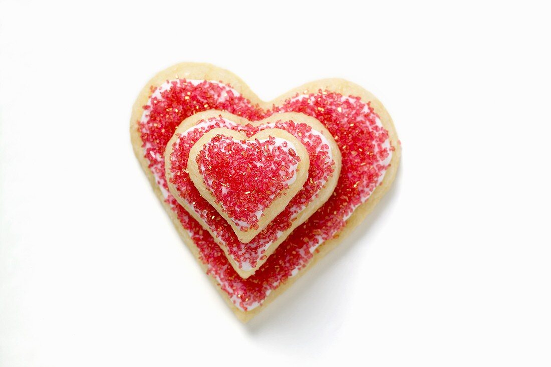 Heart-shaped biscuits with red sugar, in a pile