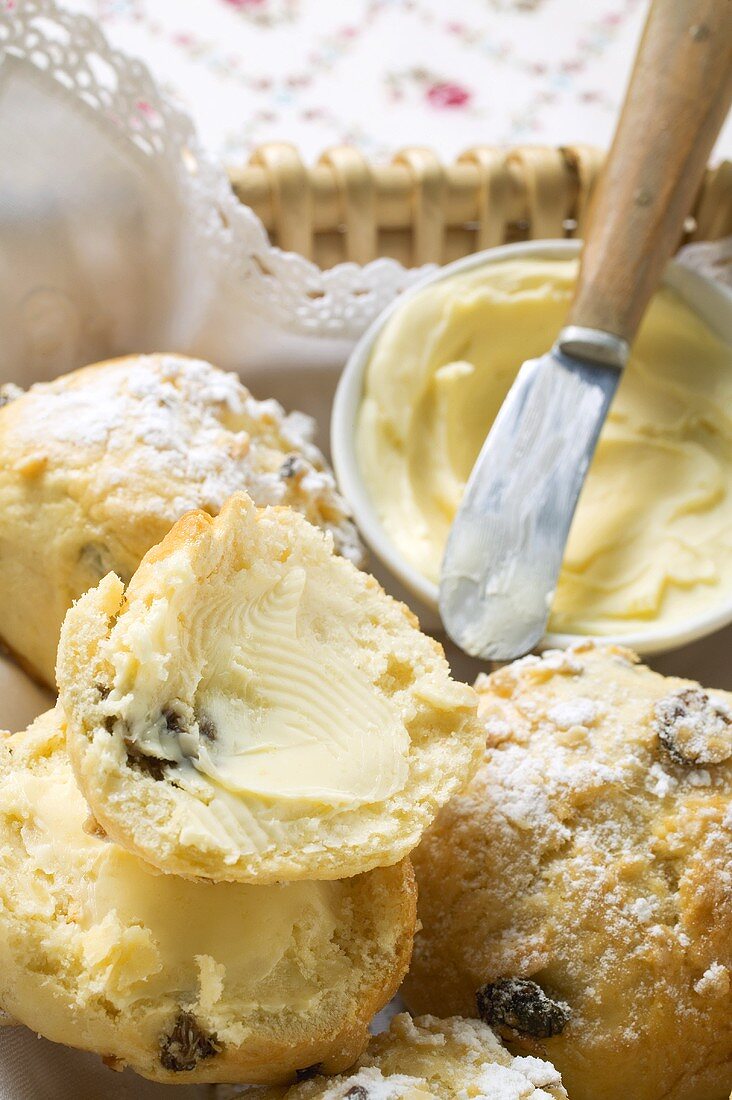 Sugared raisin scones with butter in bread basket