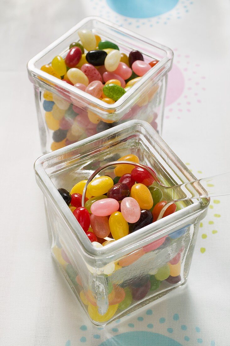 Coloured jelly beans in two storage jars