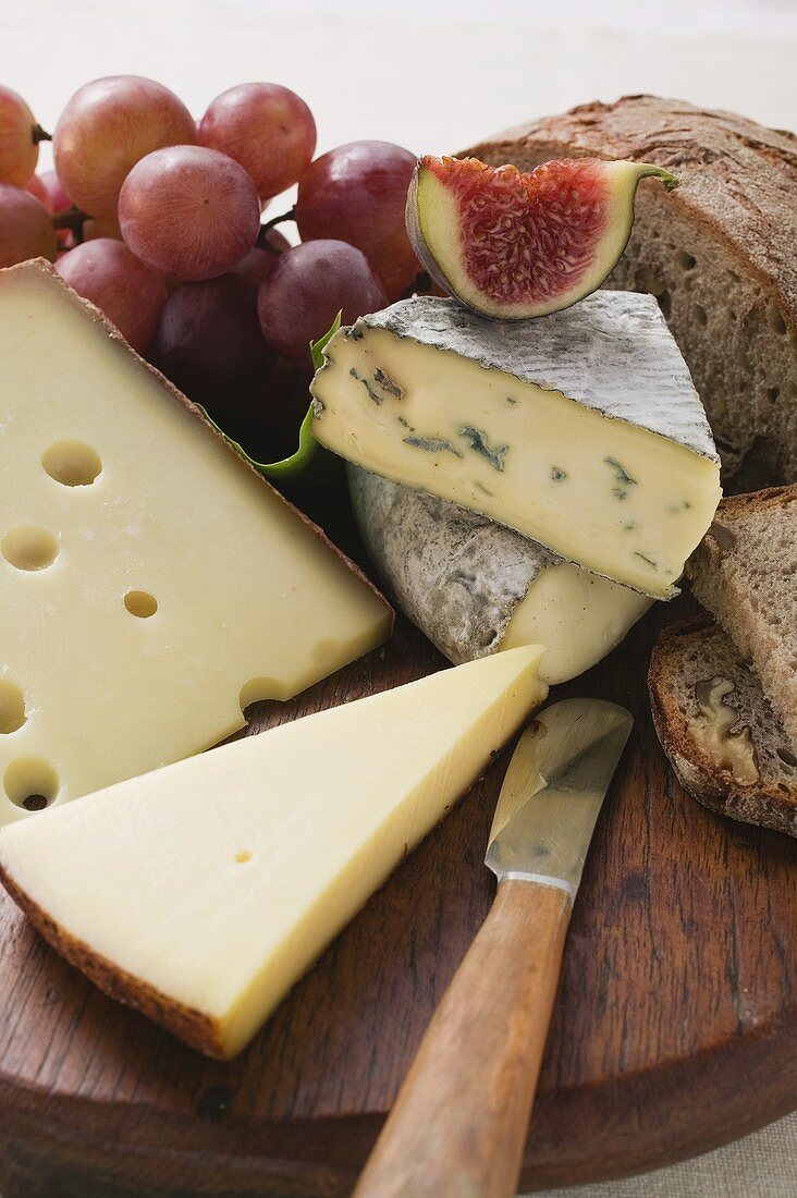 Cheese board with grapes, fig and bread
