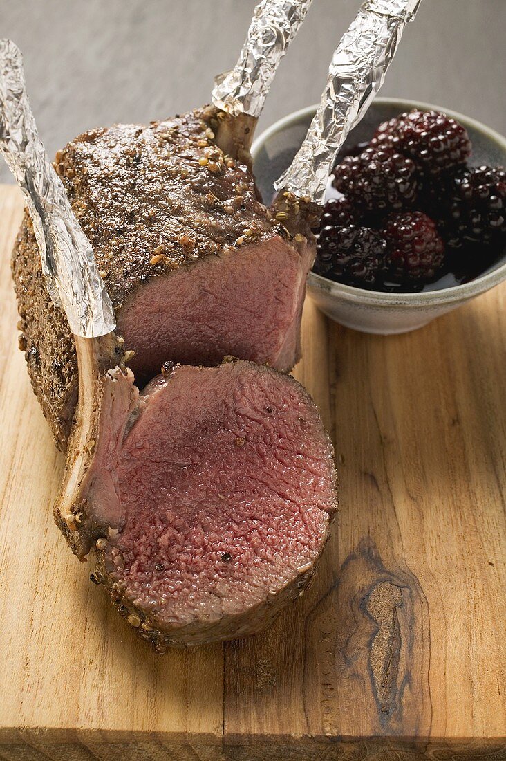 Rack of venison, partly carved, with blackberries