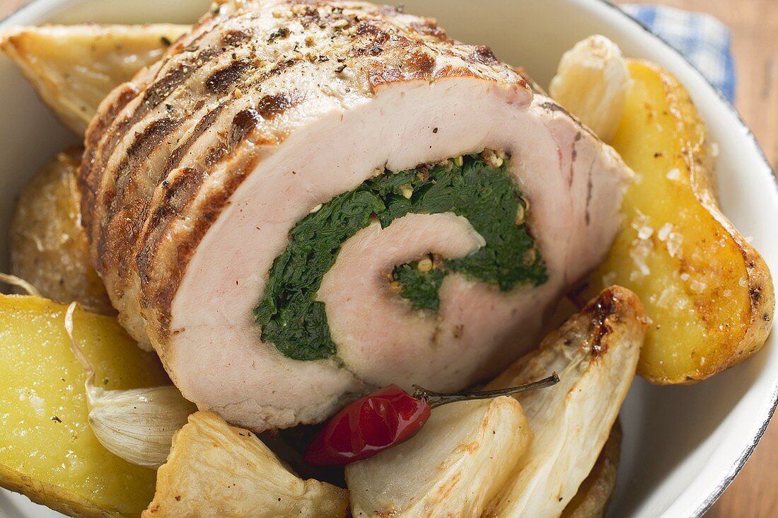 Stuffed, rolled pork roast with celeriac and potatoes