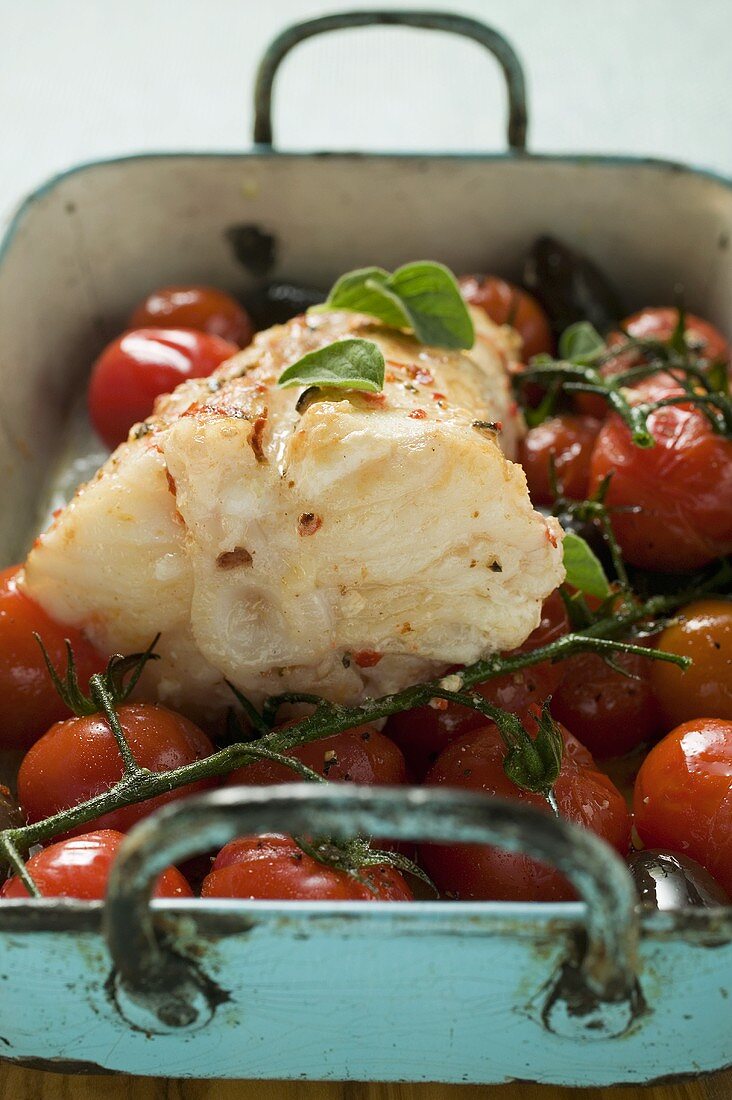 Monkfish with cherry tomatoes and olives in roasting tin