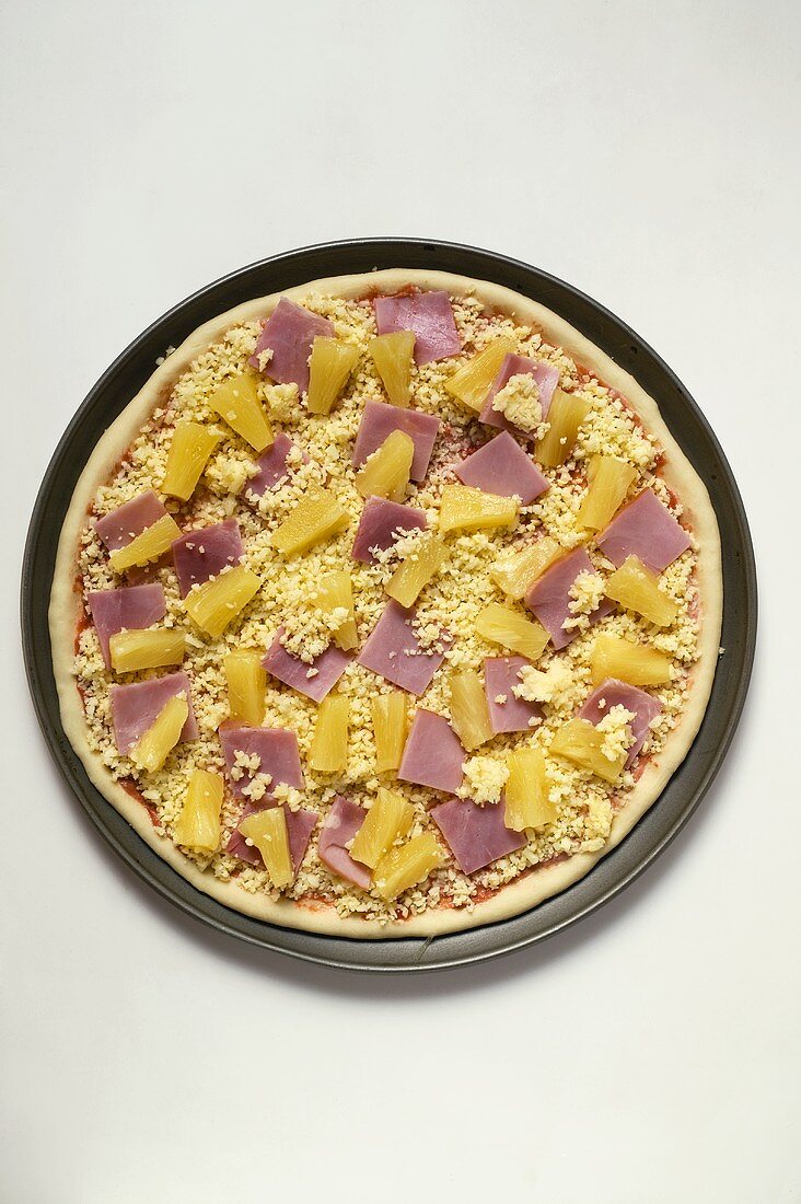 Hawaiian pizza with ham and pineapple (unbaked)