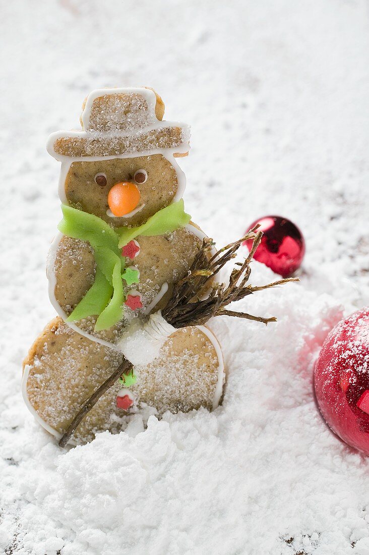 Spiced pastry snowman in winter landscape