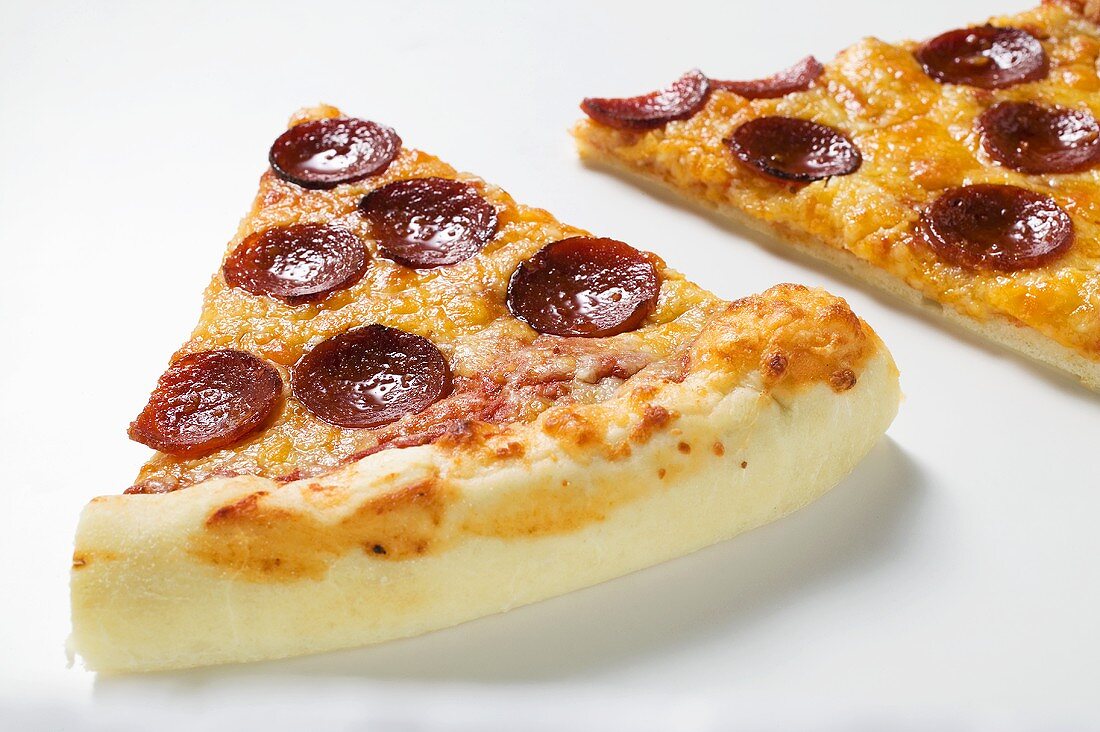 Two slices of American-style pepperoni pizza