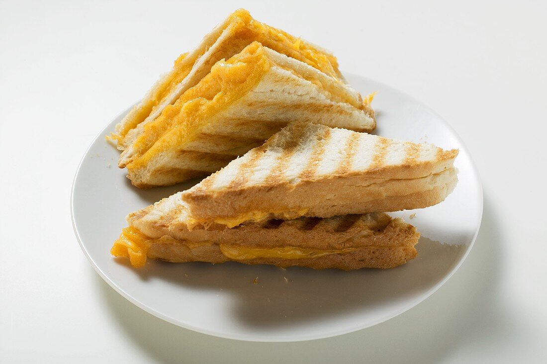 Several toasted cheese sandwiches on plate