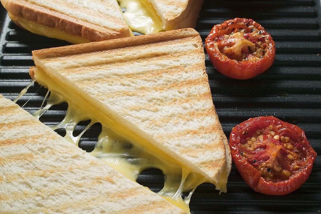 Käsetoasts und Tomaten auf Plattengrill (Close Up)