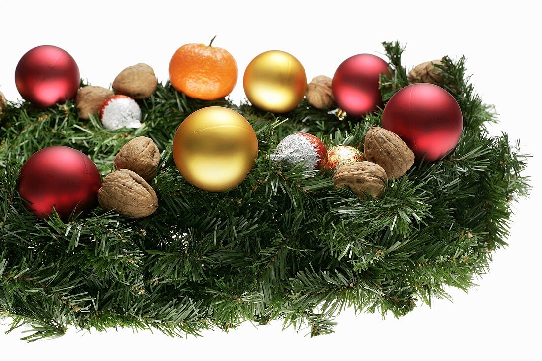 Christmas arrangement of fir sprigs, baubles and nuts