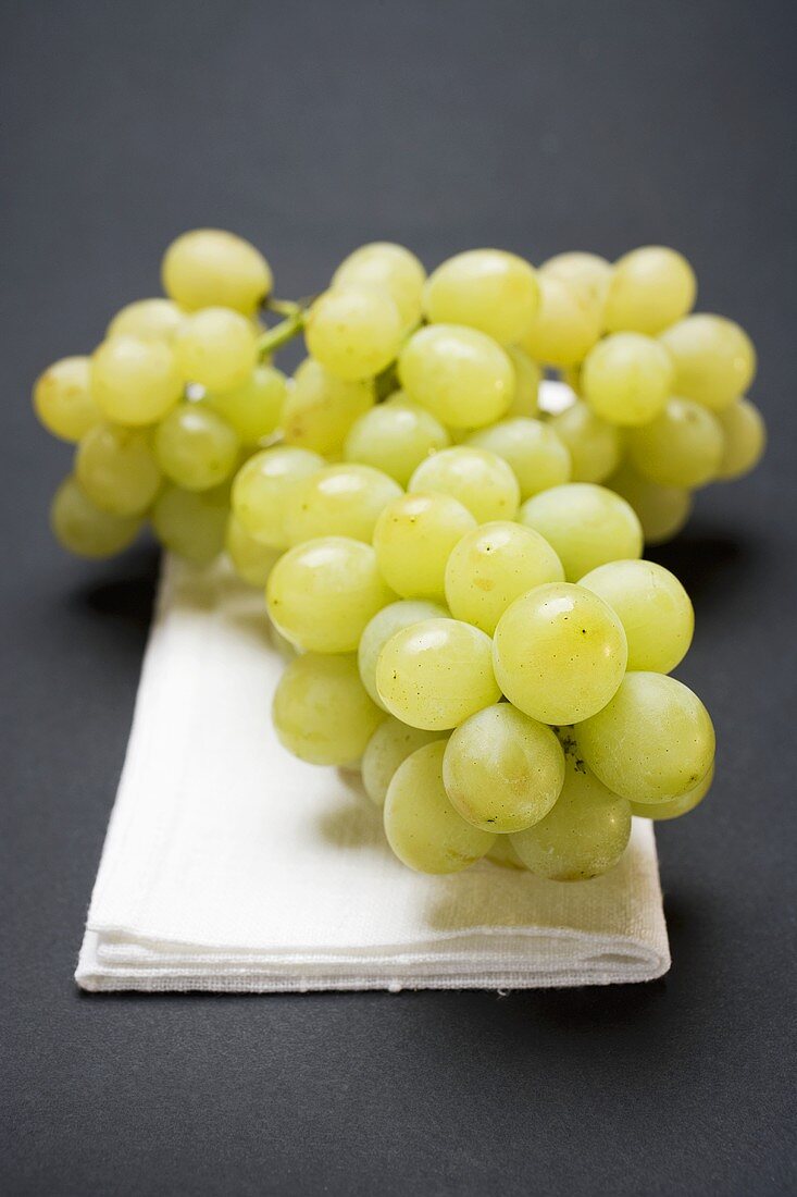 Green grapes on linen cloth