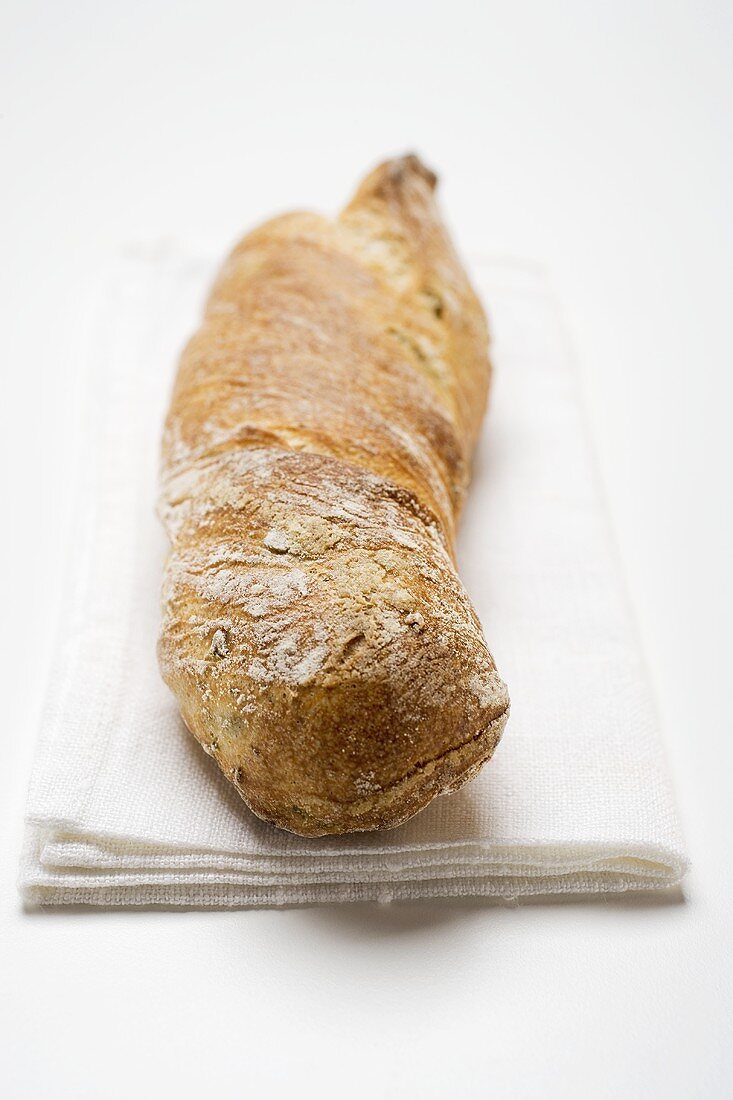 Rustic baguette on white cloth