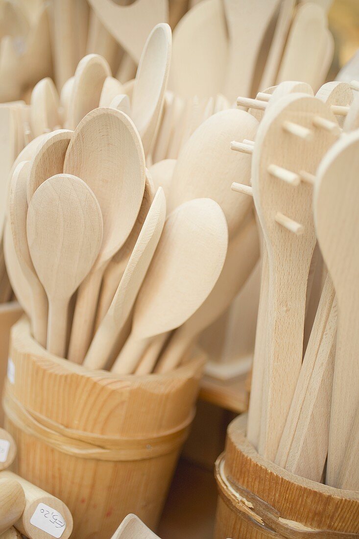 Wooden spoons in wooden buckets at a market