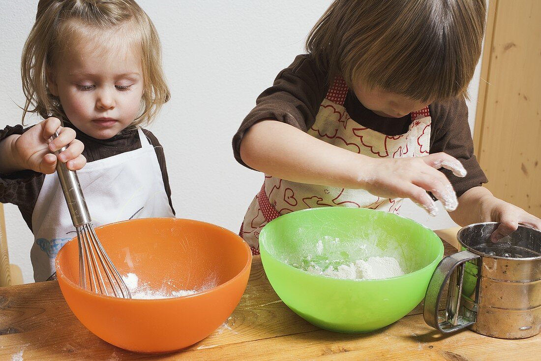 Two children baking