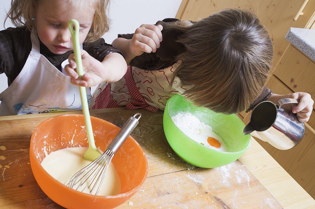 Two children baking