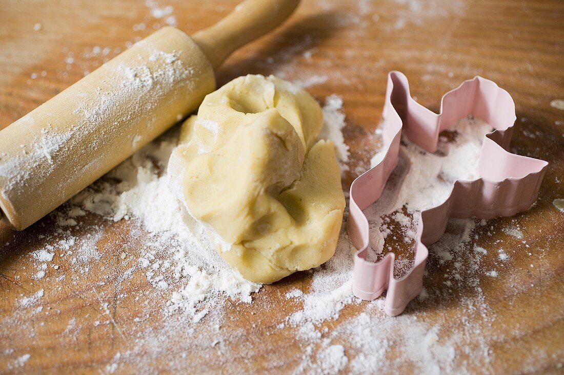 Biscuit dough, biscuit cutter, flour and rolling pin