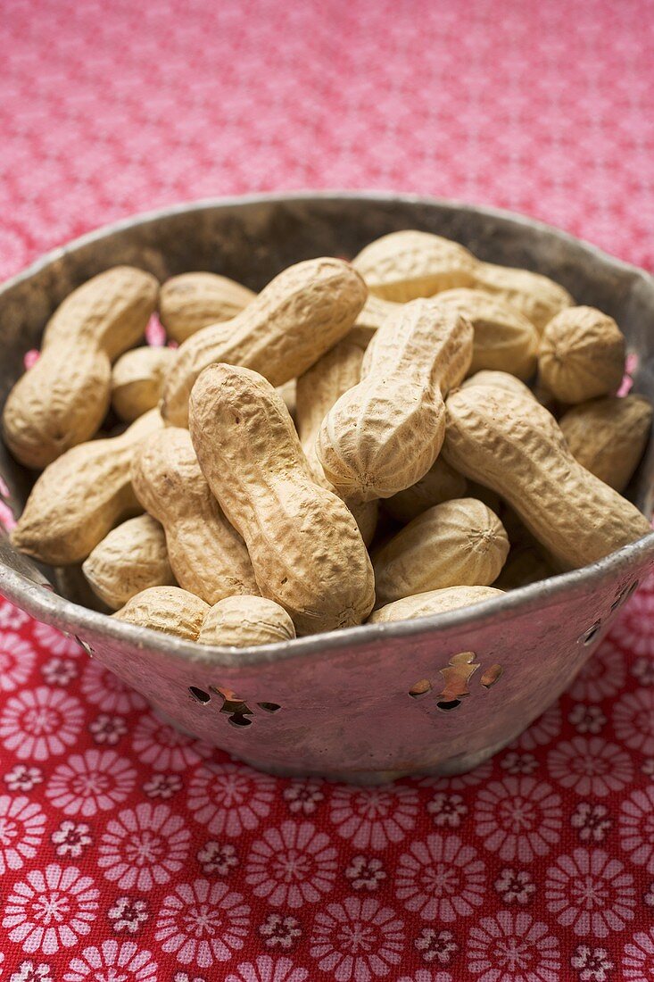 Several peanuts in bowl