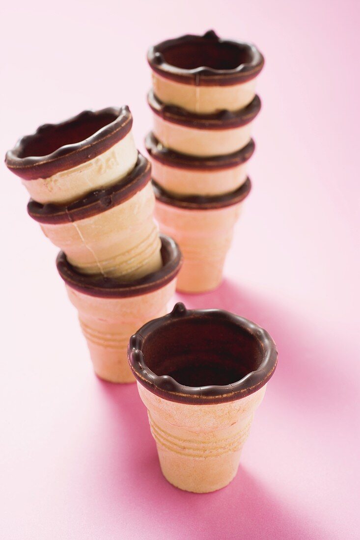Empty chocolate-dipped ice cream cones, in a pile