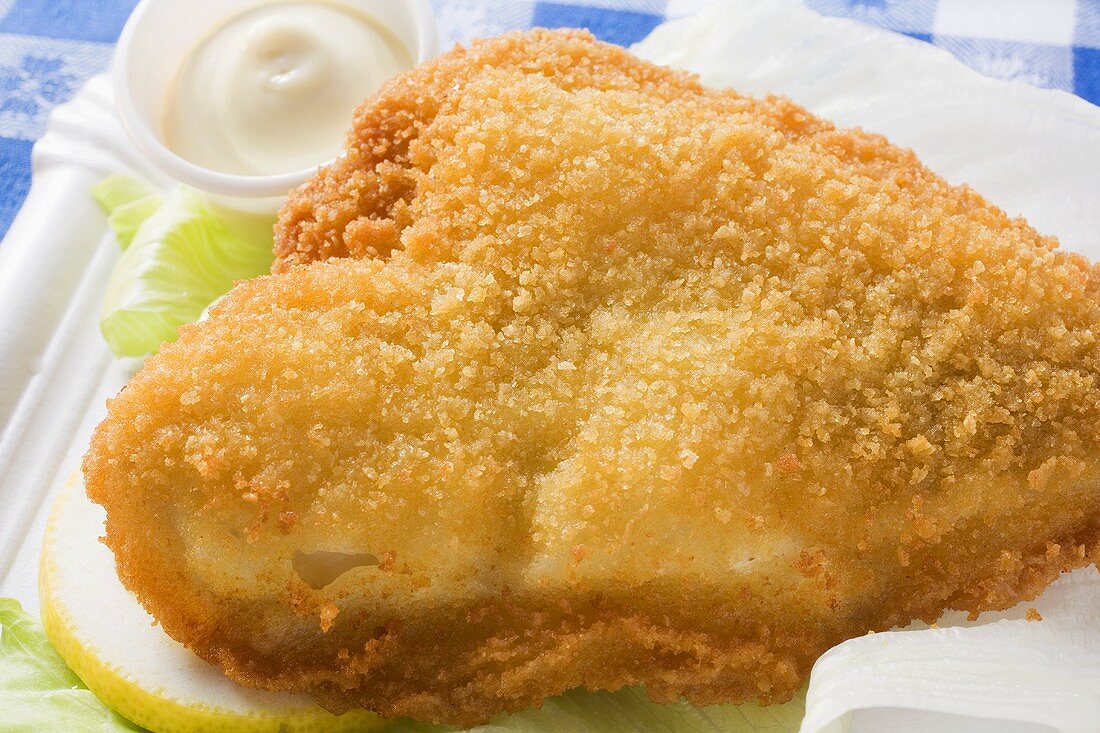 Breaded fish fillet with mayonnaise (close-up)