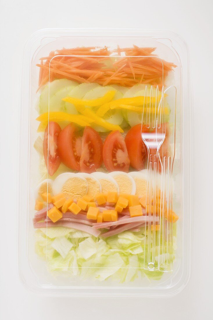 Iceberg lettuce, ham, cheese, egg & vegetables in plastic tray