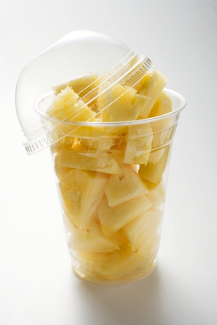 Pineapple chunks in a plastic beaker