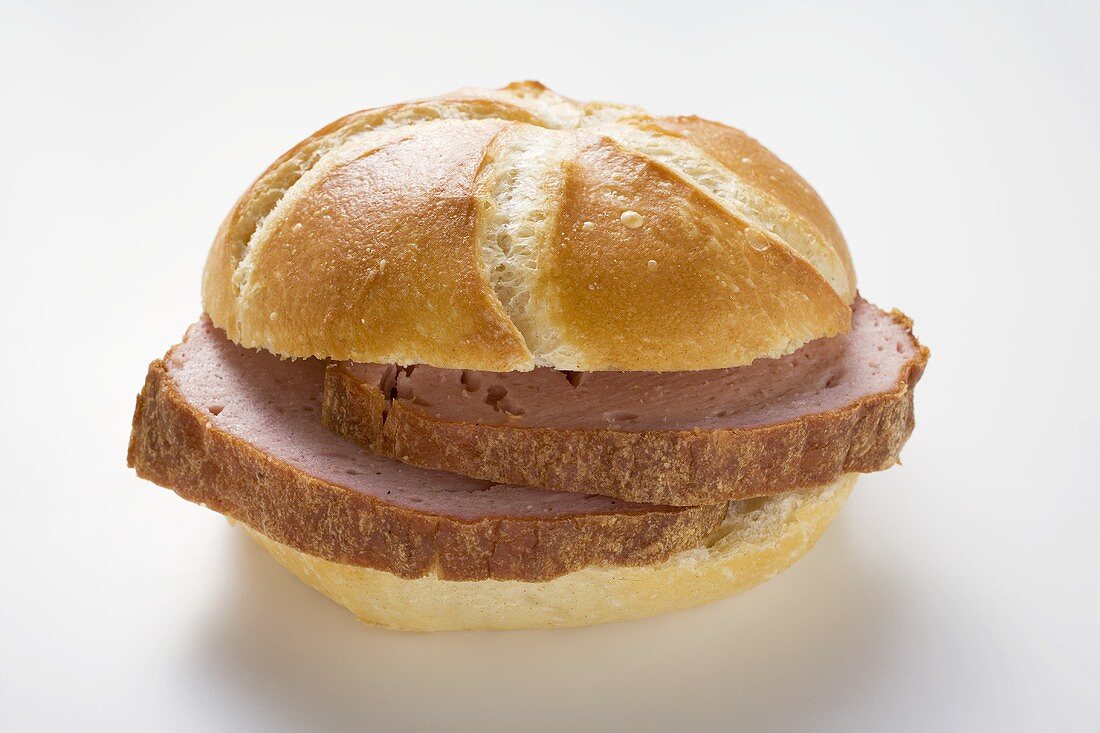 Slices of Leberkäse (a type of meatloaf) in a roll