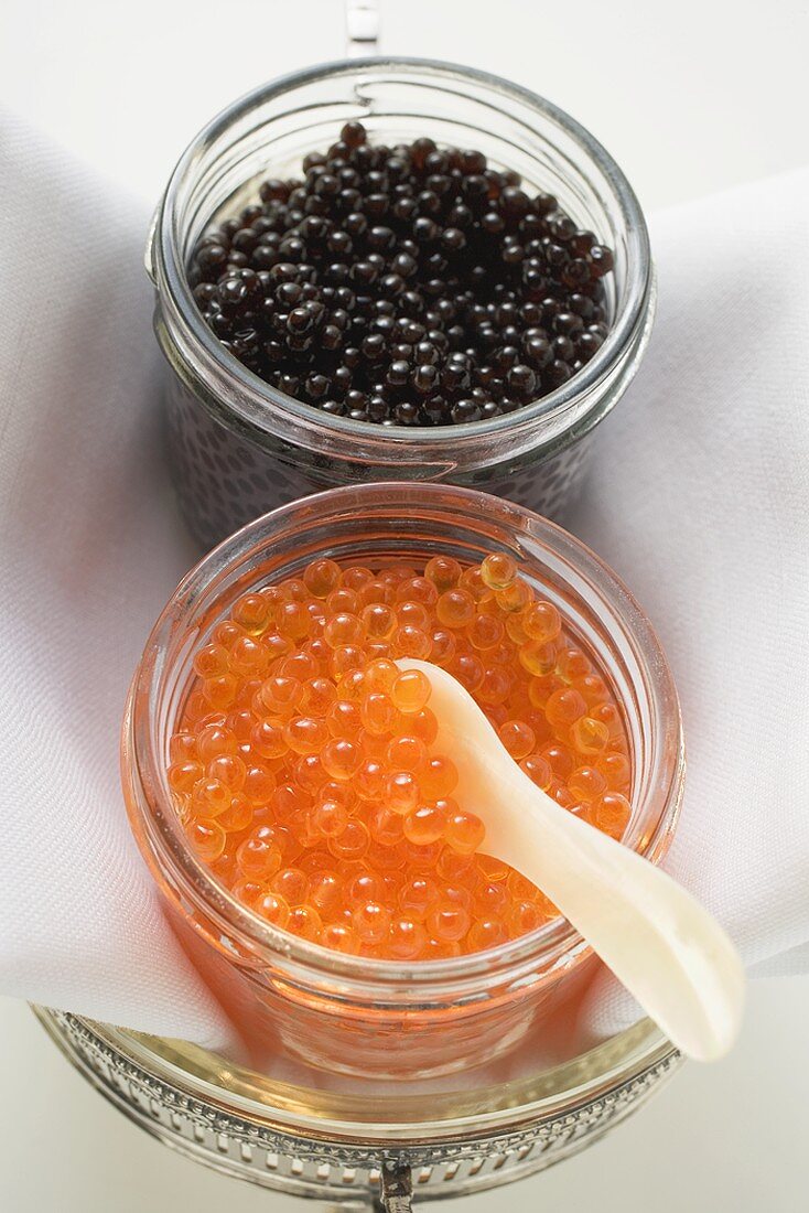 Black caviar and Keta caviar in jars (overhead view)