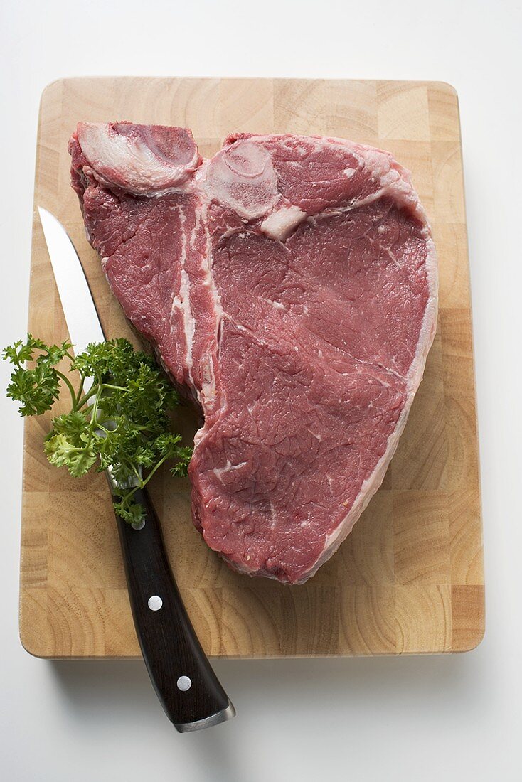 T-bone steak on chopping board