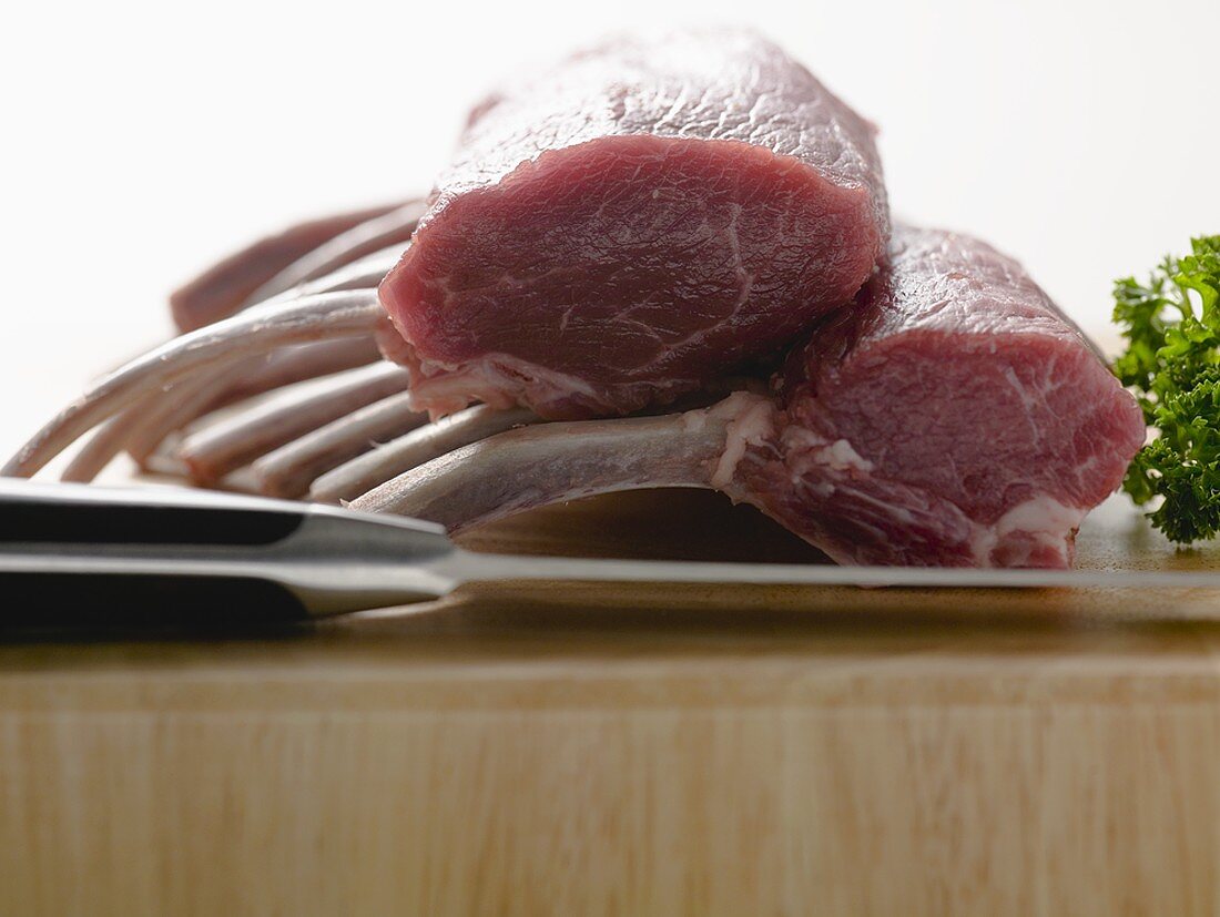 Racks of lamb on chopping board with knife