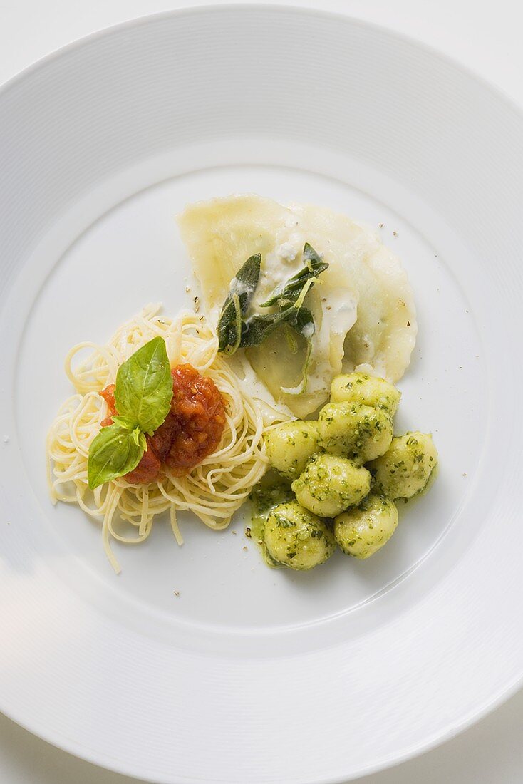 Tris di pasta (three different types of pasta) on a plate