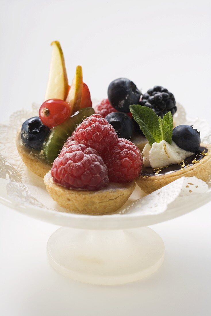 Assorted fruit tarts on cake stand