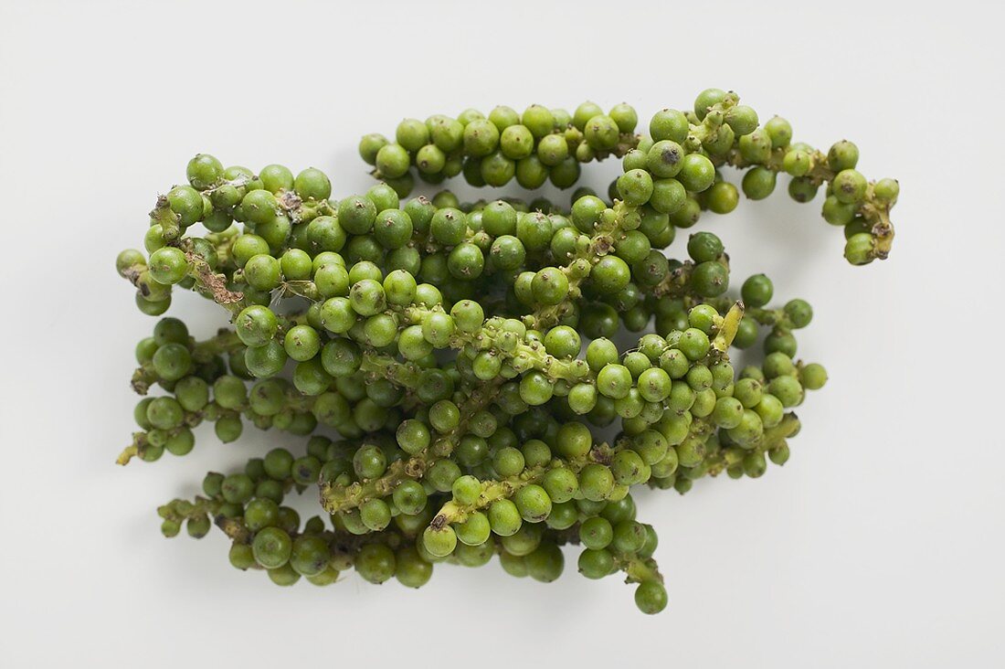 Clusters of green peppercorns