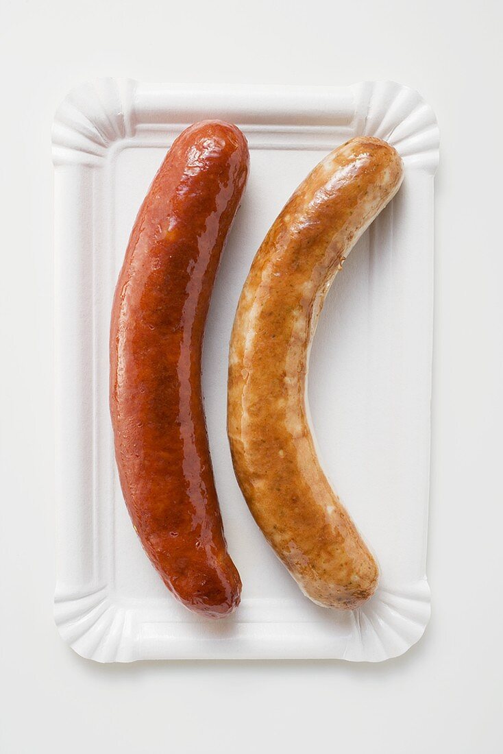 Two sausages (bratwursts) on paper plate