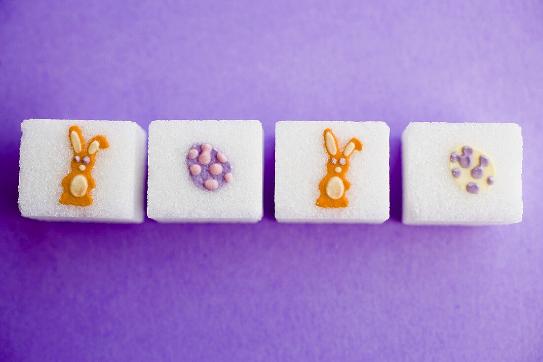 Sugar cubes with Easter decorations in a row