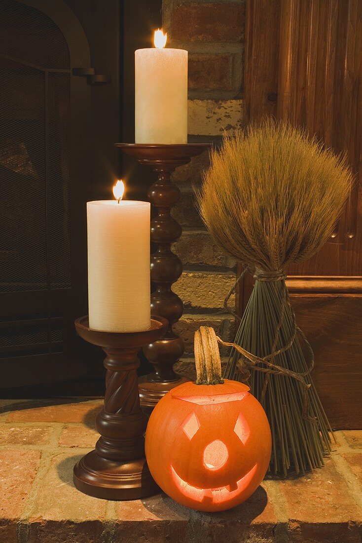 Autumn decorations: candles, cereal sheaf & pumpkin lantern