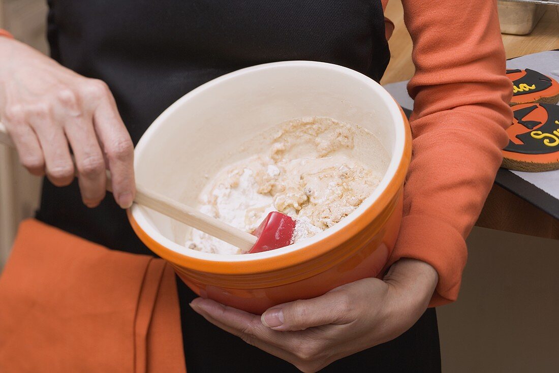 Woman stirring mixture in a baking bowl