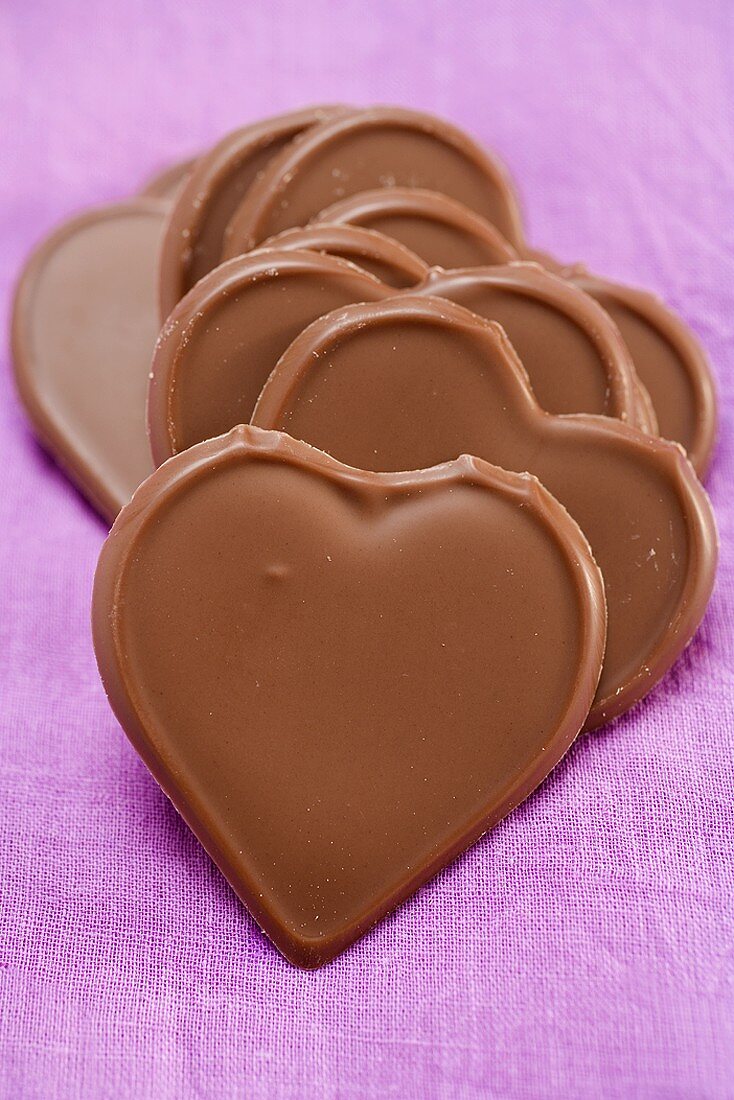 Chocolate hearts on purple background