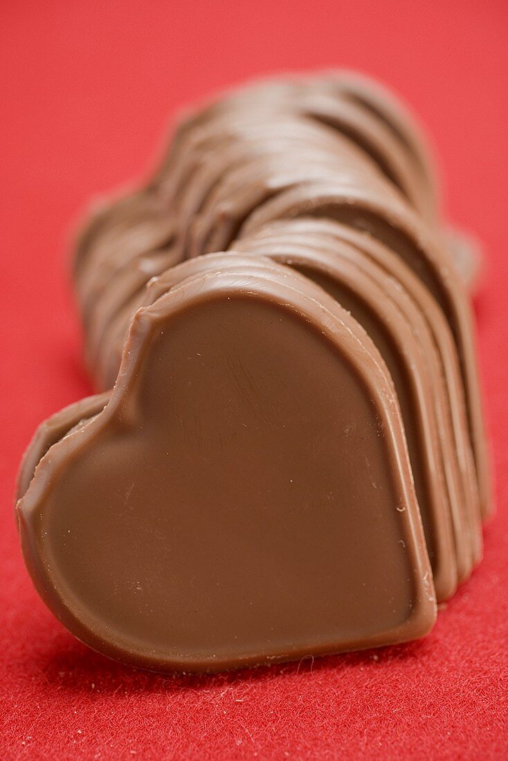 Chocolate hearts on red background