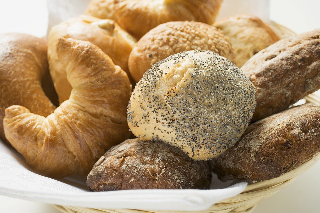 Bread rolls and croissants in bread basket