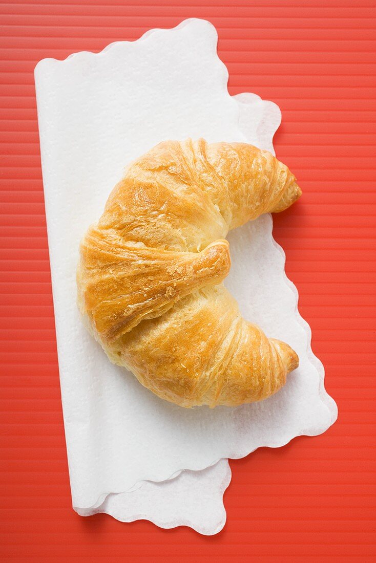 Croissant on paper napkin (overhead view)