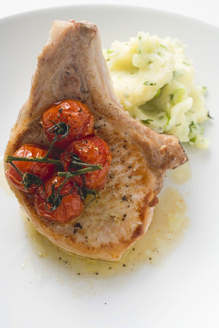 Fried pork chop with cherry tomatoes and mashed potato