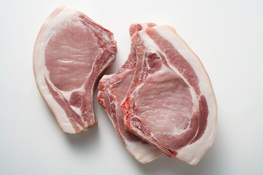 Three raw pork chops