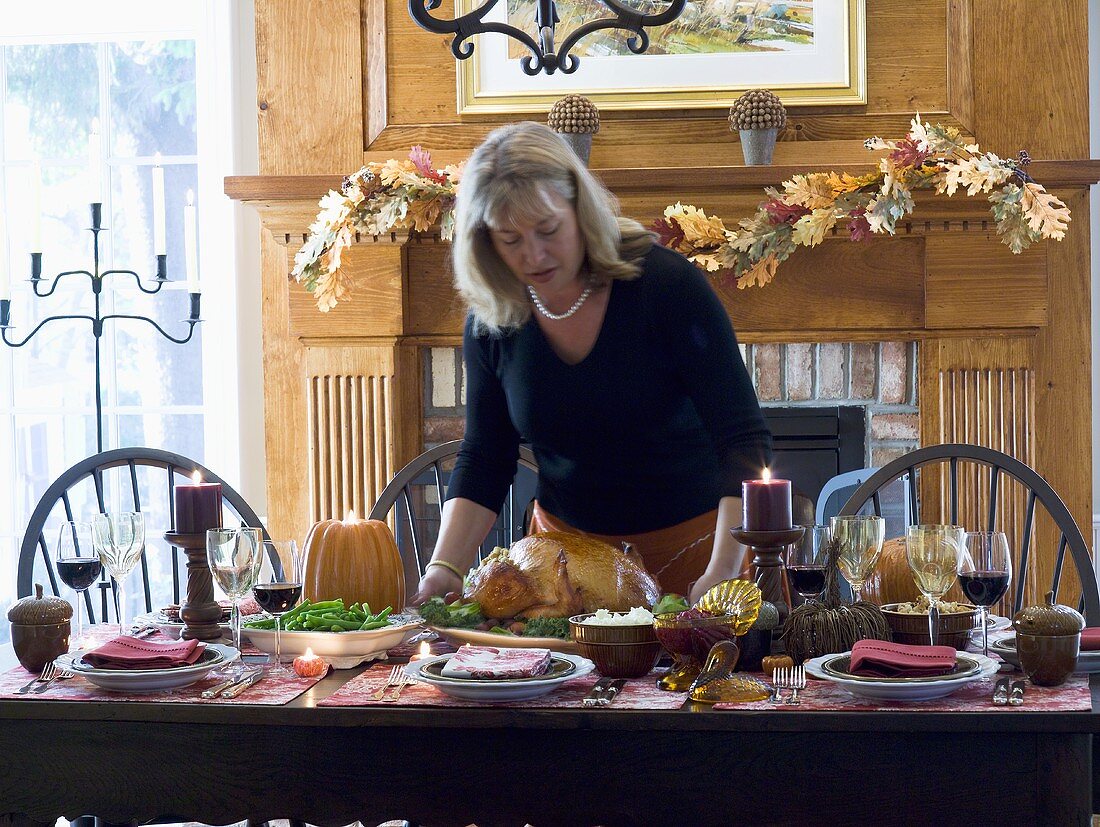 Woman serving stuffed turkey for Thanksgiving (USA)