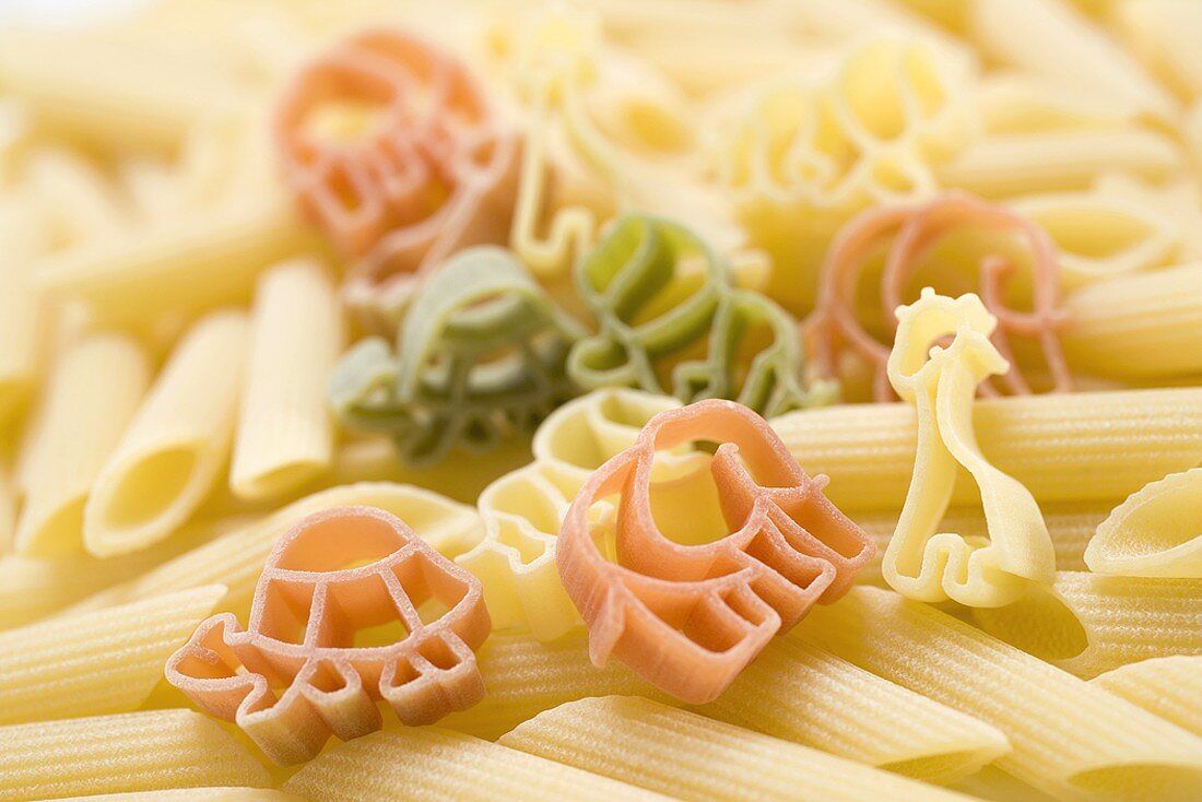 Coloured animal-shaped pasta and penne – License Images – 959918 ❘ StockFood