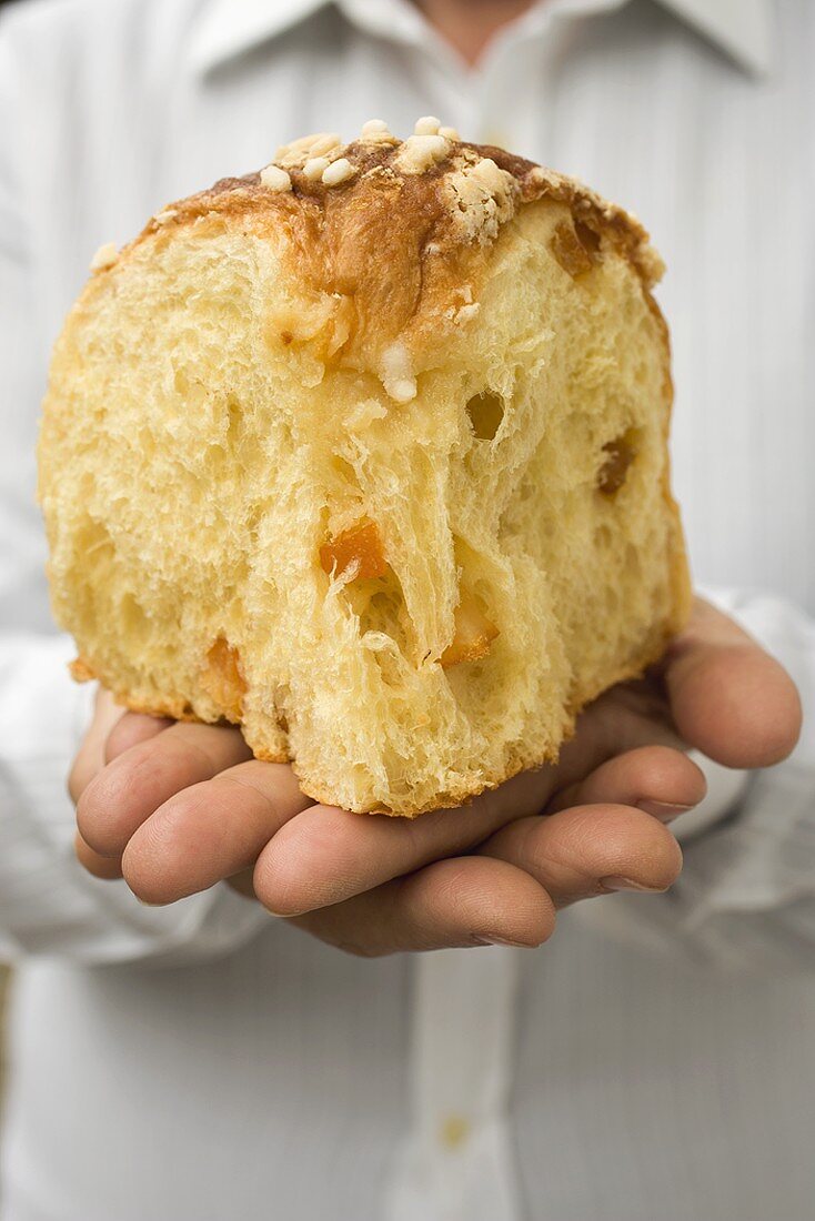 Hands holding piece of yeast cake